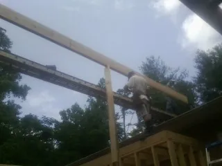 Carpenter setting a ridge beam over a new addition frame — Ice Dam Removal by Roofing Brothers in Marine On Saint Croix