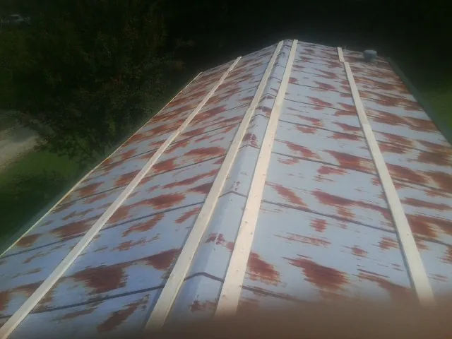 Rusted metal roof panels with new wood purlins before replacement — Storm Damage Roof Repair in Marine On Saint Croix by Roofing Brothers