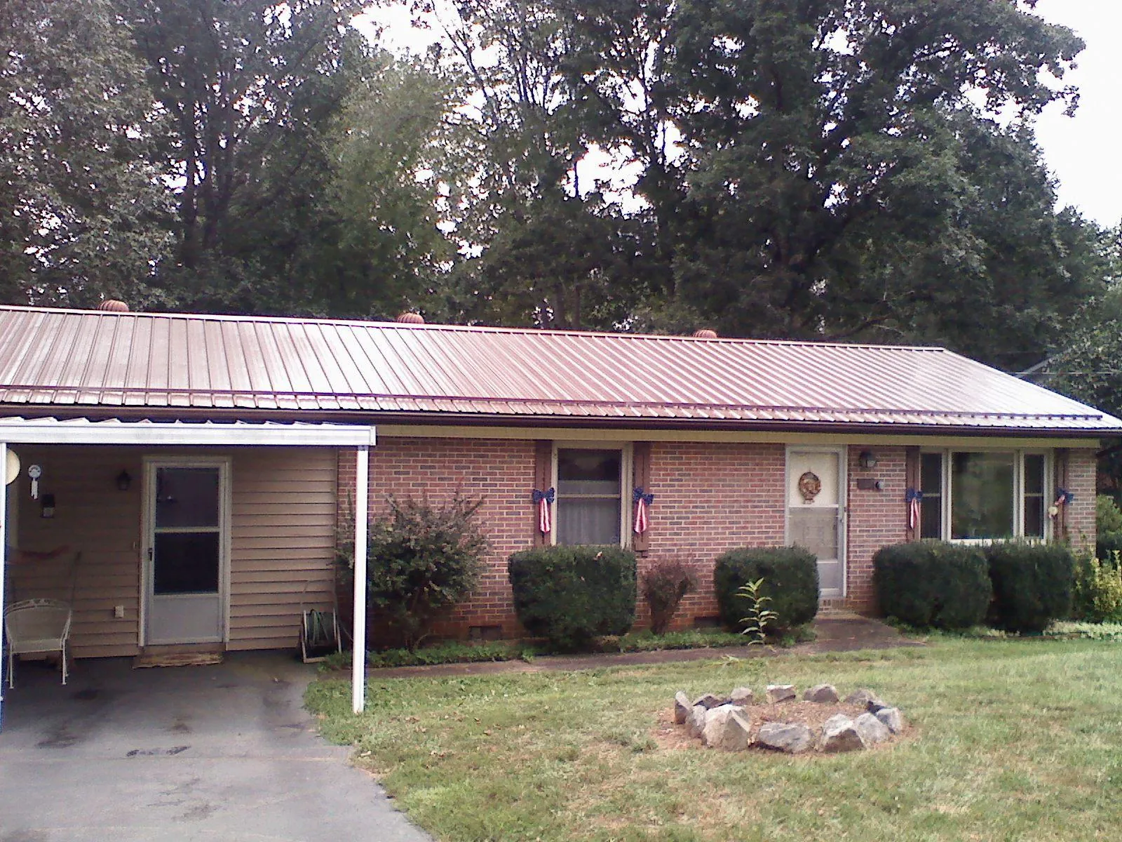 Bronze metal roof and carport on a brick ranch home — Roof Repair work by our crew in Marine On Saint Croix